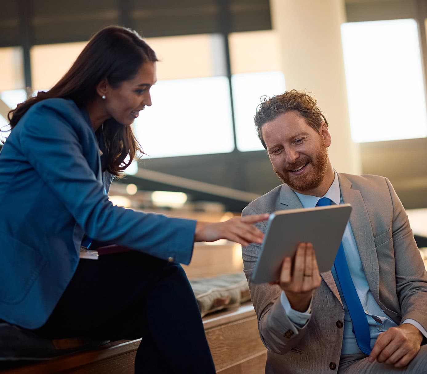 happy business colleagues working on digital table