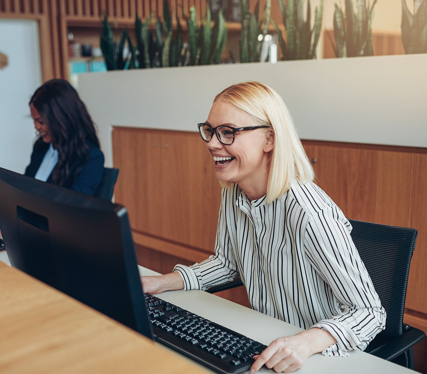laughing businesswoman working with a colleague