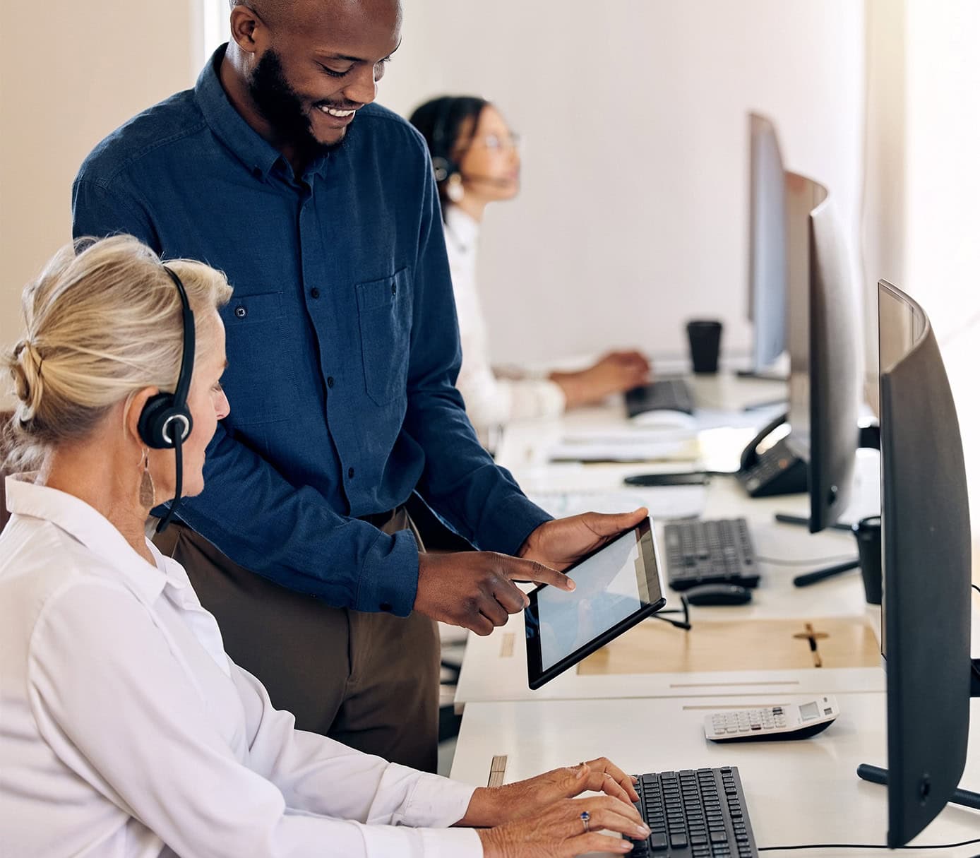shot of two call centre agents working together