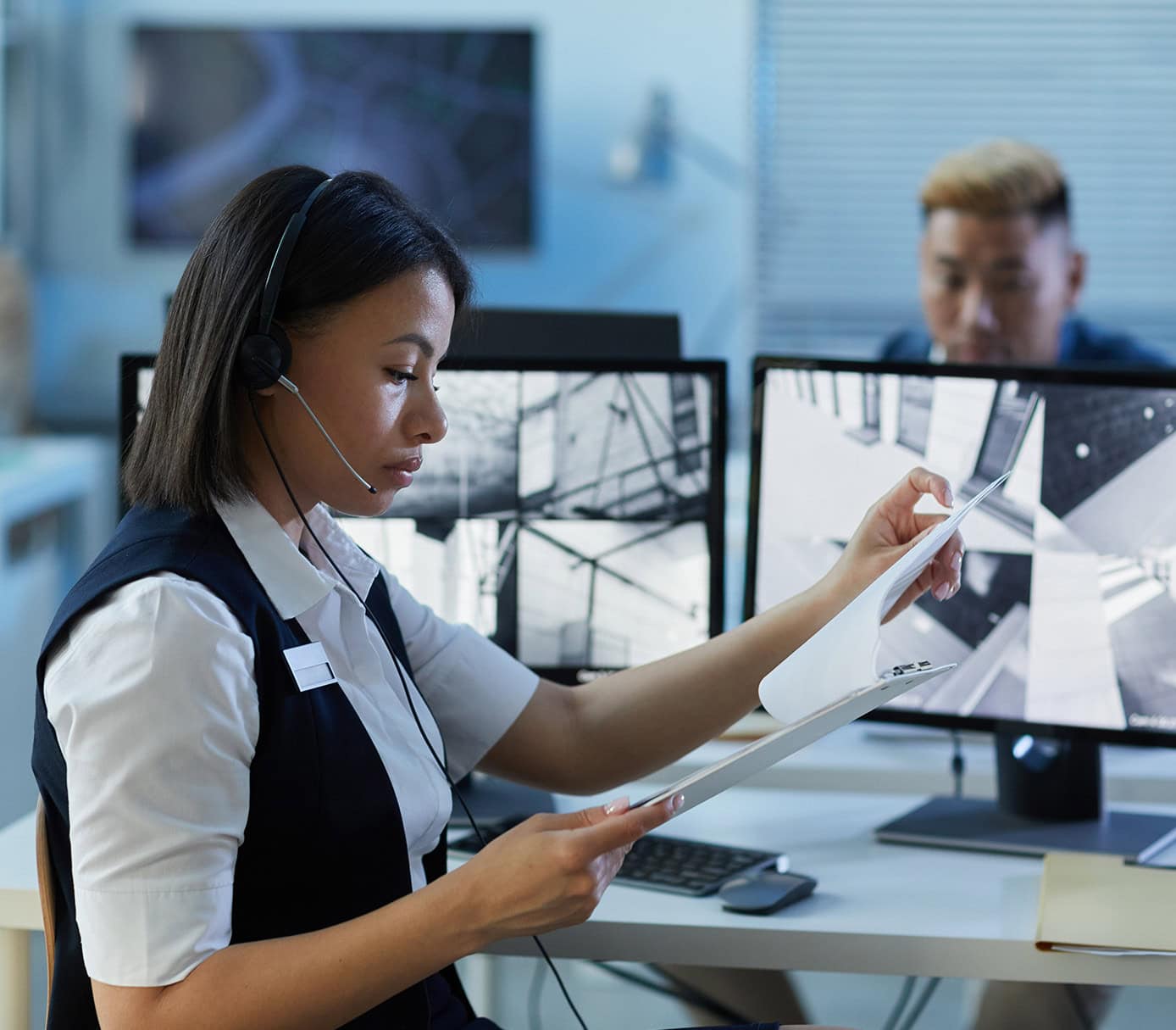 young woman wearing headset in security center young woman wearing headset in security center